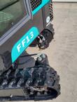 FF13 final drive motor and hydraulic hoses at the rubber track, below the model decal on the black upper body