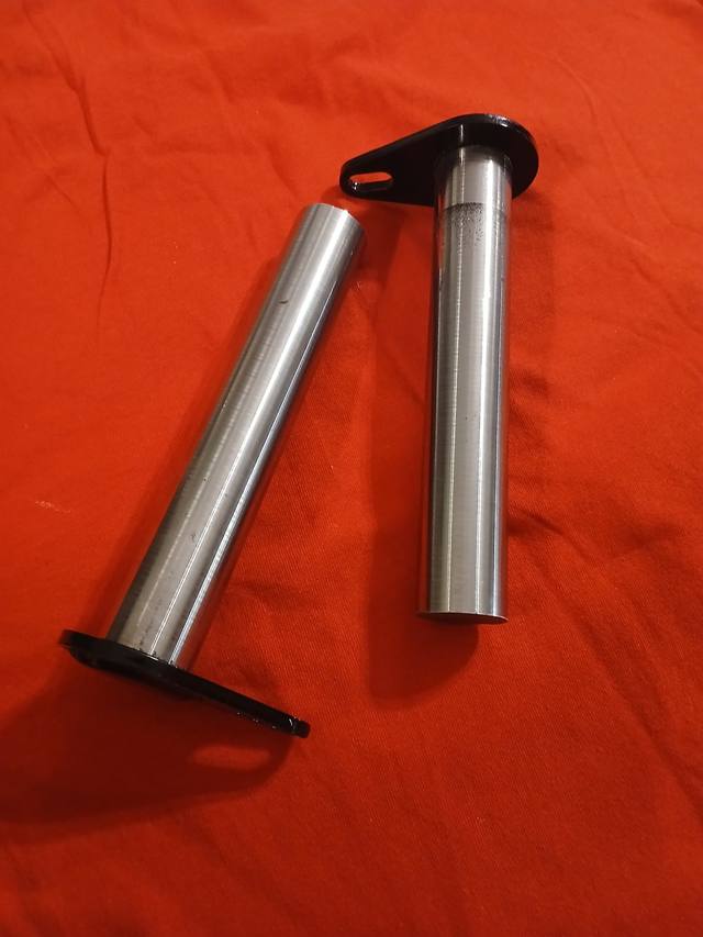 Two long hardened steel attachment plate pivot pins with black flag plates