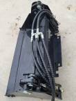 Black 4-in-1 bucket angled from above, mount frame and four braided hydraulic hoses running to the cylinders