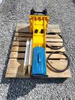 SDCH680 hydraulic breaker on a pallet from above with two chisels, blue tool box and two coiled hoses