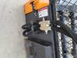 Hydraulic manifold block and hose connections on the bale processor's mesh backstop