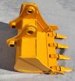 Yellow excavator bucket from the back, twin pin-boss mounting ears above four bolt-on teeth