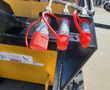 AGT MX-CRT23 auxiliary hydraulic quick-couplers with red dust caps at the front of the loader arm