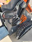 AGT YSRT14 auxiliary hydraulic hoses coiled along the loader arm above the rubber track and diamond-plate platform