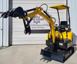 FF15 mini excavator, boom raised high: digging bucket with the hydraulic thumb open, backfill blade down, canopy and seat