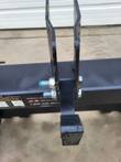 Adapter top-link bracket: paired upright steel tabs bolted to the crossbar