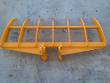 Yellow excavator rake from above, seven curved tines on a tubular frame with twin pin bosses centered