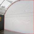 Interior view of a container shelter's white fabric back wall, outlined in red