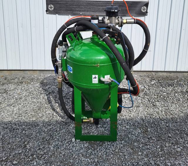 Green DB500 dustless blast pot on a two-wheel cart, tank inlet valve for water, coiled blast hose and air lines
