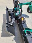 Soil conditioner's quick-attach plate and hydraulic hoses, with the yellow angle-control switch and warning label