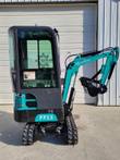 FF13 mini excavator from the rear quarter: enclosed cab, teal boom folded with thumb and bucket, rubber tracks