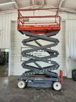 Skyjack SJIII 3226 scissor lift raised, scissor stack extended indoors