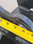 40-inch tilting bucket's mounting yoke, tape measure held across the pin bore