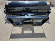 AGT angle broom from the mount side, black brush hood and skid steer quick-attach plate
