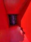 Crushing rotor with carbide teeth inside the red hopper, comb plates on either side of the drum
