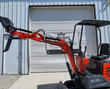 MX15R mini excavator with boom and arm extended and bucket raised, black canopy over the operator seat