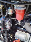 SDLE20 mini excavator diesel engine bay: fuel filter and water separator bowl, fuel lines, alternator and starter