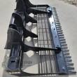 Wolverine land leveler from above: bolt-on ripper teeth, screening bars between the blades, quick-attach plate at rear