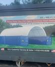 Printed spec banner on the crate: 15oz PVC container roof shelter over two blue containers, 20x40x6.5