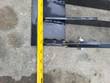 Tape measure across the grapple's frame rail, reading about 44 inches