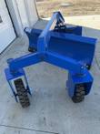Blue 6-way dozer blade grader from above and behind, showing full width and both caster wheel arms