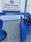 Dozer blade's end corner, rubber cutting edge along the bottom and hydraulic hoses at the mount