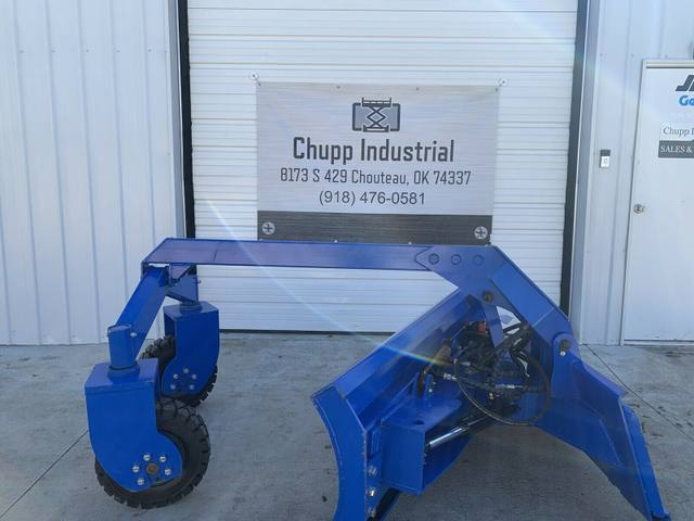 6-way dozer blade's skid steer quick-attach frame and dual caster wheels, blade angled to the side