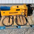 SDCH680 hydraulic breaker in profile: yellow body, black mounting bracket, blue tool box and two hoses