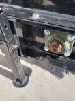 Angle broom shaft end with green flange bearing and adjustable support leg above the sweeping bristles
