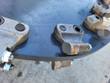 Stump grinder wheel edge: carbide cutting teeth in bolt-on holders, hex bolts and light surface rust on the steel