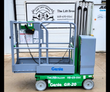 Genie GR-20 vertical mast lift, side view: green base, gray platform with guardrails and coiled control cord