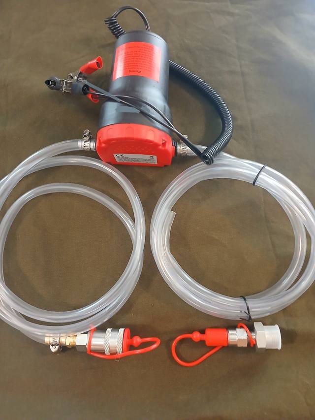 12V oil transfer pump with battery clamps, two clear hoses and quick-connect tank drain fittings