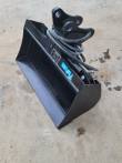 Black Future hydraulic tilt bucket, open shell interior with tilt head, data plate and coiled hoses