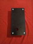 Black steel engine mounting plate from above with four threaded mount studs, hex nuts and bolt holes