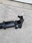 Auger drive housing bolted to its quick-attach mounting bracket with twin pin lugs