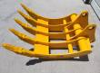 Yellow TOFT08R excavator rake from above, five curved tines with bolted tips, CAT320 marked on the frame