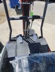 MX15RX travel levers and foot pedals on the diamond-plate operator floor
