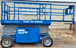 Blue Genie GS-3369RT 4x4 rough-terrain scissor lift, lowered, side view, knobby off-road tires