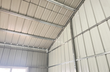 Interior of the metal workshop: galvanized steel frame, purlins and ribbed wall and roof panels