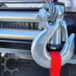 Arteer logging winch: forged slip hook with safety latch and red pull strap on the steel cable, drum behind