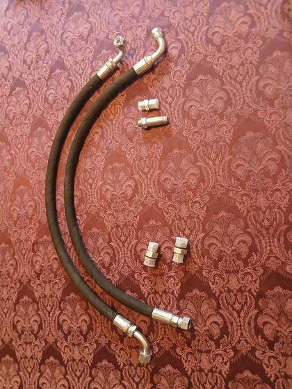 Two 1/2 in hydraulic pressure hoses with 90-degree swivel ends, plus four adapter fittings