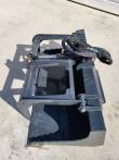 Gray flat-bottom grapple bucket, grapple arm open over the shell with hydraulic cylinder and hoses