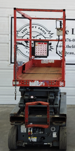 Skyjack SJIII 3219 scissor lift, platform lowered, rear view