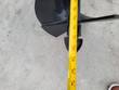 Tape measure across the mini excavator auger bit's flighting to check its width