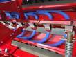 No till seed drill seed metering row: blue seed tubes running from the meters to the openers on the red frame