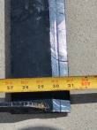 Tape measure across the land leveler's flat steel blade, extended past 31 inches