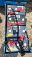 Boom lift battery bank, four batteries with red jumper cables
