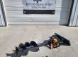 Mini skid steer auger laid out full length: black flighted bit, orange drive gearbox and quick-attach mount plate