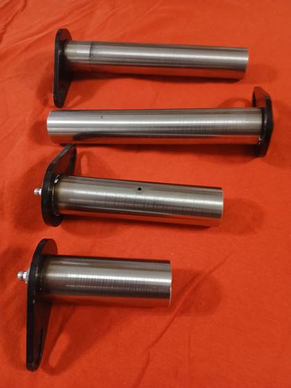 Four polished 4140 hardened steel machine pins with black retainer flags, two with grease fittings