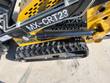 MX-CRT23 decal on the yellow mini skid steer's side, lift cylinder above the black rubber track